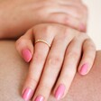 Adjustable Pearl Band Ring in Gold on Model with Pink Nails
