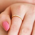 Close Up of Adjustable Pearl Band Ring in Gold on Model