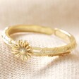 April Daisy Birth Flower Ring in Gold on Beige Fabric