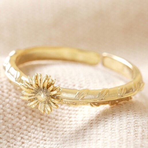 April Daisy Birth Flower Ring in Gold on Beige Fabric