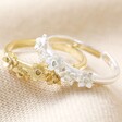 Birth Flower Rings in Gold and Silver on Beige Fabric