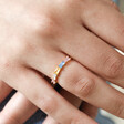 Close Up of Model Wearing Colourful Baguette Crystal Band Ring in Gold on Ring Finger