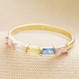 Colourful Baguette Crystal Band Ring in Gold on Beige Fabric