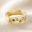 Multicoloured Crystal Daisy Band Ring in Gold on neutral coloured fabric