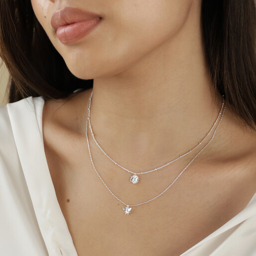 Close Up of Set of 2 Daisy and Bee Necklaces in Silver on Model