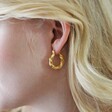 Close Up of Model Wearing Twisted Rope Hoop Earrings in Gold