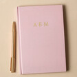 Front Cover of Personalised Bold Name Fabric Notebook in Pink with Pen
