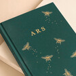 Close up of debossed initials on the Personalised Initials Bee Fabric Notebook