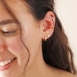 model smiling wearing Tish Lyon Solid Gold Crystal Bubble Barbell with curated ear look