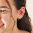 Model Wearing Tish Lyon Solid White Gold Star Helix Earring as part of a Curated Ear