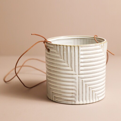 Empty Burgon & Ball Grey Modena Hanging Planter on a pink surface