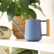 Burgon & Ball Heritage Blue Watering Can Lifestyle Shot with Plants in Background