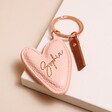 Personalised Caroline Gardner Vegan Leather Peach Heart Keyring on pink surface