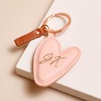 Pretty Personalised Caroline Gardner Vegan Leather Peach Heart Keyring on pink background
