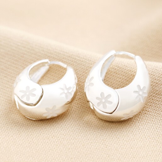 Estella Bartlett Chunky Flower Dome Hoops in Silver on Beige Coloured Fabric