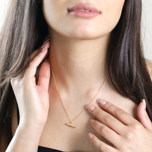 Brunette Model Wearing Estella Bartlett Flower T-Bar Necklace in Gold