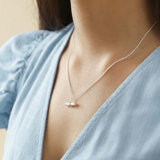 Close Up of Model Wearing Estella Bartlett Flower T-Bar Necklace in Silver