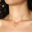 Model wearing Estella Bartlett Kiss Pendant Necklace In Gold