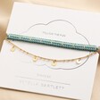 Estella Bartlett Set of 2 Blue and Gold Bracelets Arranged on Packaging Card