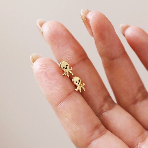 Model Holding Sterling Silver Octopus Stud Earrings in Gold