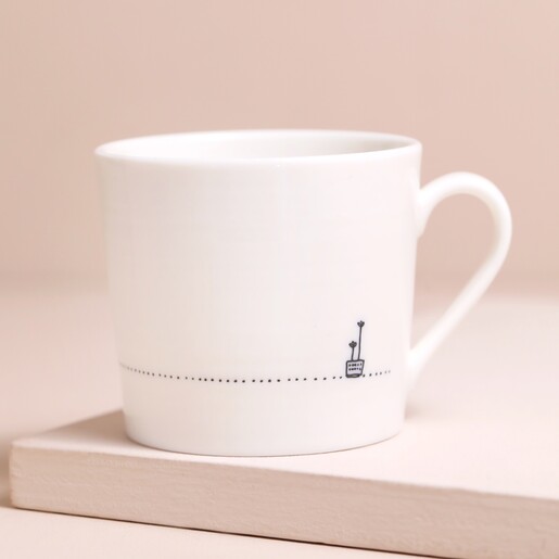 Back of East of India A Brew Will See You Through Mug on Beige Surface