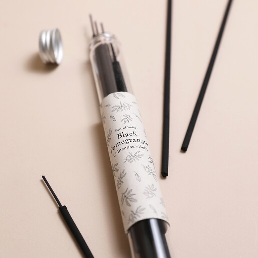 East of India Black Pomegranate Incense Sticks jar open with incense sticks on neutral background