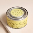 East of India Sending Sunshine Scented Tin Candle on Beige Coloured Background