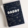 Best Daddy in the Universe Greetings Card with White Envelope Laying Flat on Surfac