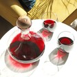 Lifestyle Shot of Sagaform Wine Carafe with Personalised Oak Stopper Filled with Red Wine with Two Glasses