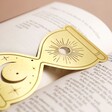 Close up Designworks Ink Celestial Hourglass Metal Bookmark Inside Open Book