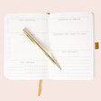 Inside of Designworks Ink Gingham Gratitude Journal with gold pen over pages