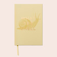 Designworks Ink What the Shell Lined Notebook against pink background