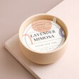Paddywax Lavender Mimosa Scented Candle with dust cover on top with neutral background