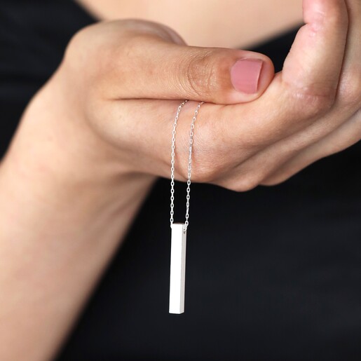 Model holding Bar Pendant Necklace in Silver in front of body