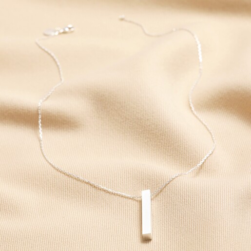 Bar Pendant Necklace in Silver full length on neutral coloured fabric