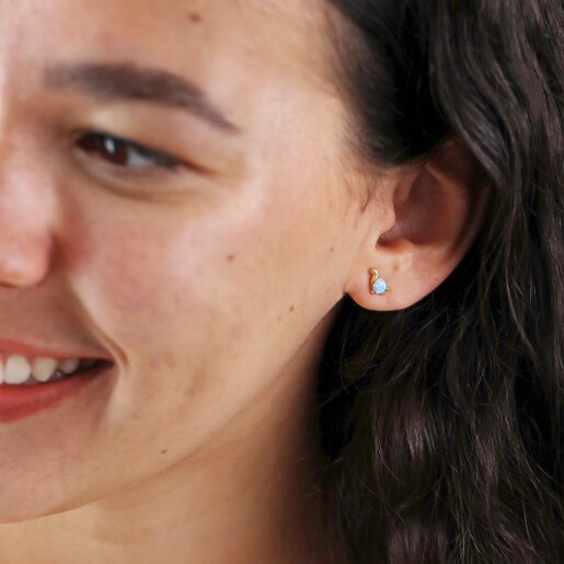 Model Smiling Looking to Side Wearing Blue Opal Dinosaur Stud Earrings in Gold