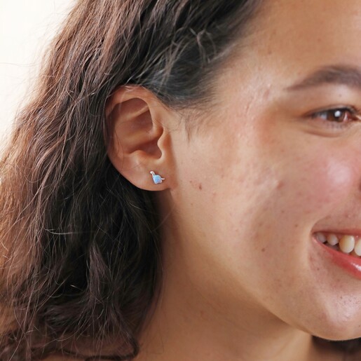 Earrings on Model Model Smiling Wearing Blue Opal Dinosaur Stud Earrings in Silver