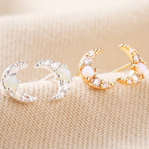 Crystal and Opal Crescent Moon Stud Earrings in Silver with Gold Studs on Beige Fabric