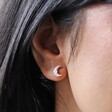 Close Up of Crystal and Opal Crescent Moon Stud Earrings in Silver on Model