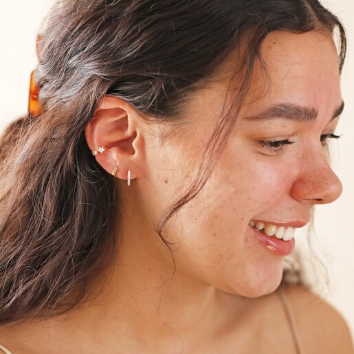 Model Wearing Crystal Star Ear Cuff in Gold With Other Earrings