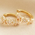 Crystal Triple Star Huggie Hoop Earrings in Gold on Neutral Fabric