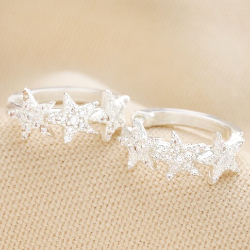 Crystal Triple Star Huggie Hoop Earrings in Silver on Neutral Fabric