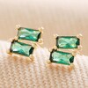 Emerald Green Stone Stud Earrings in Gold on Beige Material