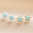 Green Opal Turtle Stud Earrings in Gold with Silver on Neutral Fabric