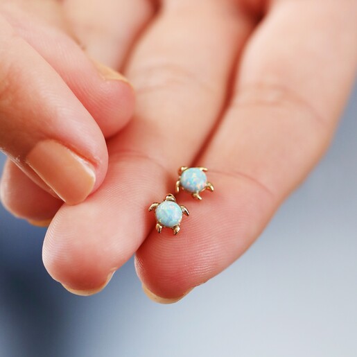 Model Holding Green Opal Turtle Stud Earrings in Gold Between Fingers