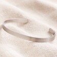 front of Men's Hand-Stamped Stainless Steel Torque Bangle on neutral coloured material