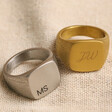 Men's Gold and Silver Personalised Brushed Stainless Steel Signet Rings on Beige Fabric