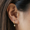 Close Up of Model Wearing Star Hoop of Mismatched Star and Lightning Huggie Hoop Earrings in Gold