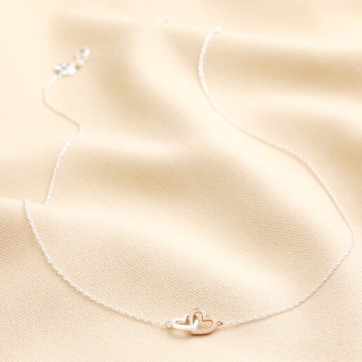 Mixed Metal Tiny Interlocking Hearts Necklace in Silver on Beige Fabric