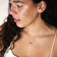 Brunette model wearing Mixed Metal Tiny Interlocking Hearts Necklace in Silver with white top